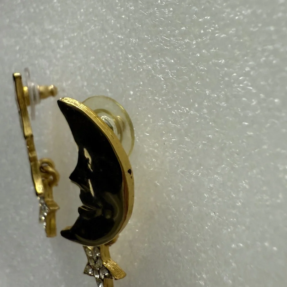 Pair of gold colored cresent earings with‎ star dangle